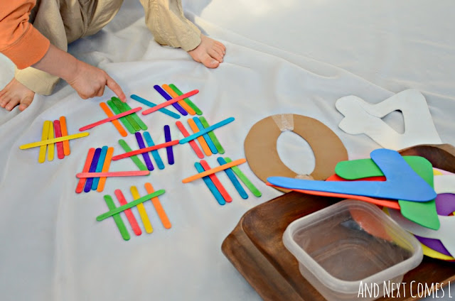 Child skip counting by five as part of a math tally marks activity