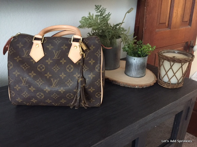 Sold at Auction: A Louis Vuitton Speedy Bag. LV canvas with brown leather  trim and handles. Lock with keys. Red textile interior. The top zip works  but is missing the puller. Please