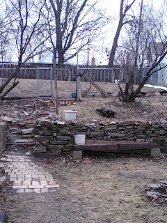 Yard devoid of snow, brown, and wet.