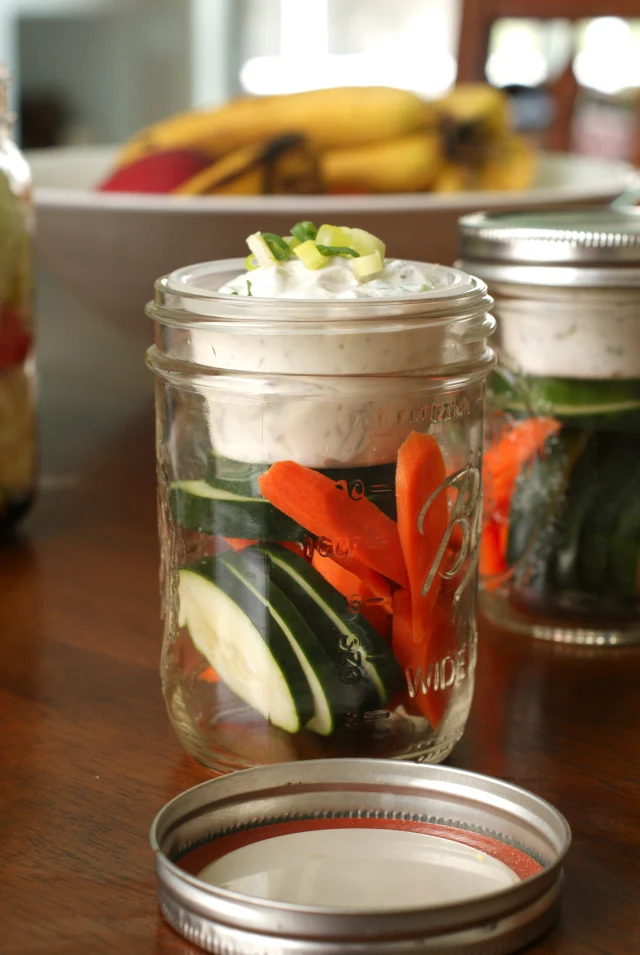 By reusing a small plastic cup and a wide mouth mason jar, you can have an easy, healthy snack to go! 
