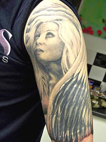 praying angel tattoo. angel wings tattoos on arm
