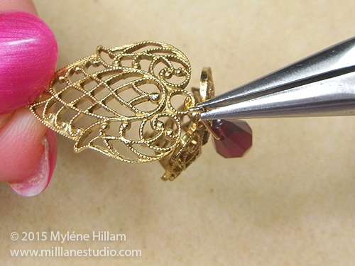 Adding another Tombac filigree onto the jump ring to create a filigree cage