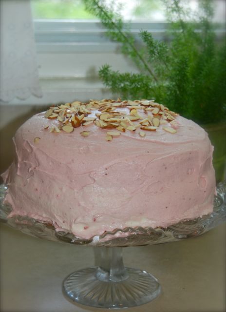 A garden party needs a yummy cake: Almond cake topped layered with fresh whipped cream and the most scrumptious strawberry icing!! 