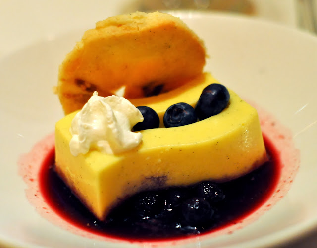 Vanilla Bean Cremeux with White Chocolate and Lemon Sable Cookie and Blueberry Sauce - Roy's Restaurant - Las Vegas, NV | Taste As You Go