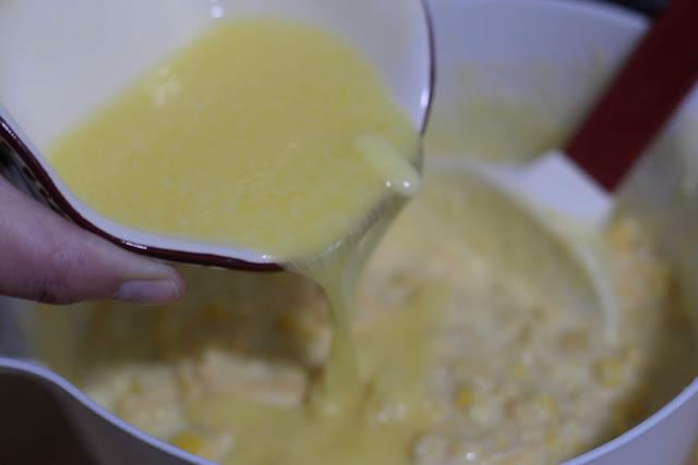 Melted butter bring added to the corn casserole mix. 