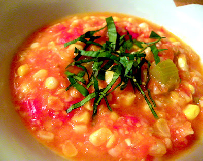 Closeup of Fresh Corn and Tomato Soup topped with Basil
