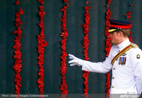 Prince Harry walks along the Roll of Honour with officials during a visit to the Australian War Memorial on April 6, 2015 in Canberra, Australia
