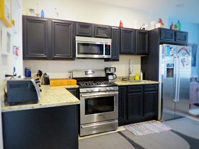 kitchen cabinets painted black using Cabinet Transformations kit