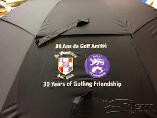 Umbrella panel with printed 30 ans de golf amitié with St Augustine's Golf Club and Golf Dunkerque logos below says 30 Years of Golfing Friendship.