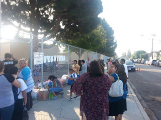 ICEF Vista parents donating goods on the first day of school  to complete the "volunteer" requirement