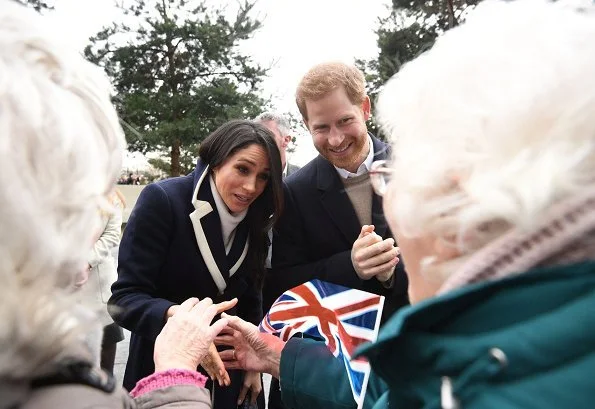 Meghan Markle wore J.Crew coat, Manolo Blahnik pumps, All Saints Ridley jumper, Alexander Wang Pants and carried Altuzarra Ghianda shoulder bag