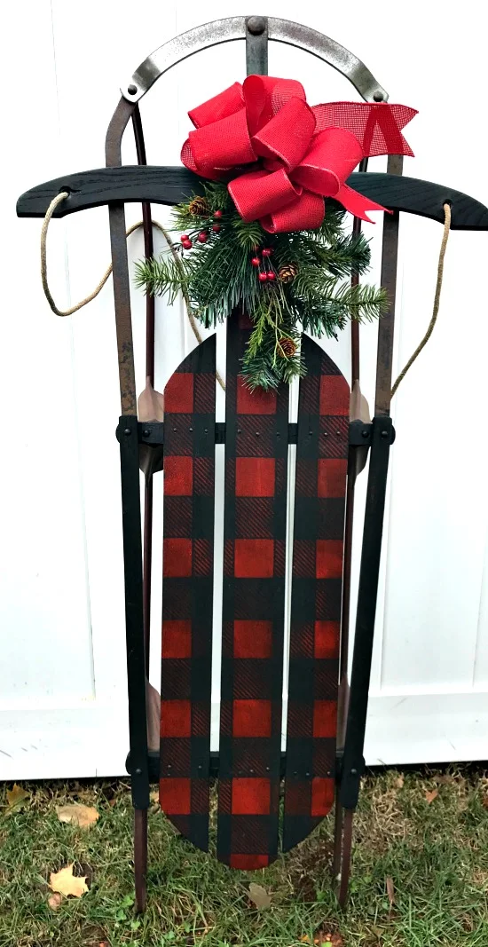 Red and Black Buffalo Check Sled with wreath and bow.