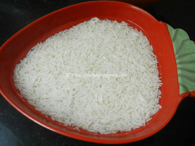 A bowl of rinsed basmati rice soaked in water for 20 minutes, ready for the next step.