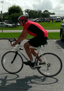 man riding bicycle in red