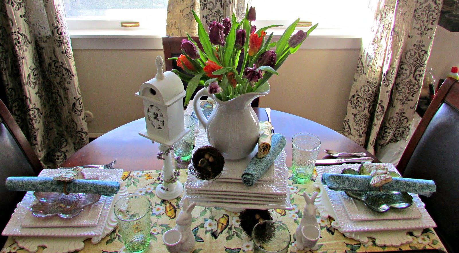 Setting a Spring tablescape using white dishes and gorgeous tulips.