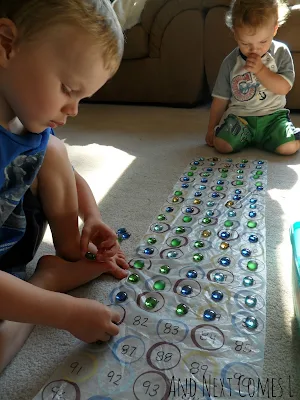 J counting on the homemade 100 chart from And Next Comes L