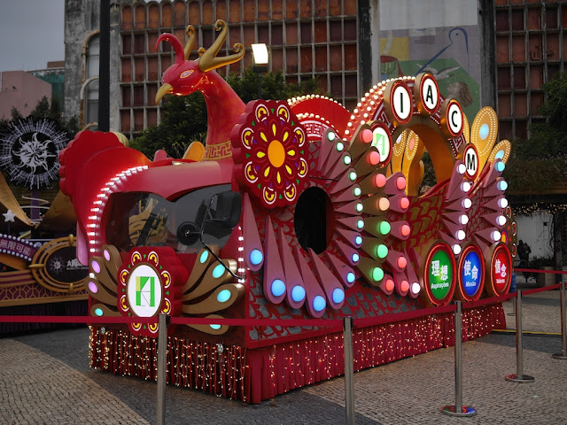Lunar New Year rooster parade float lit up at night in Macau