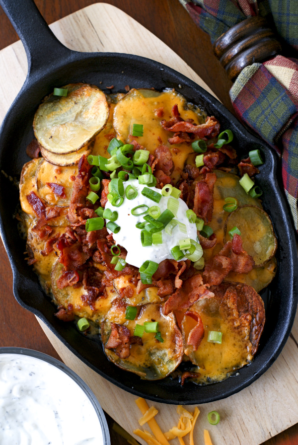 Loaded Potato Nachos are made by topping oven roasted potato rounds with all of your favorite loaded baked potato toppings, nachos-style!