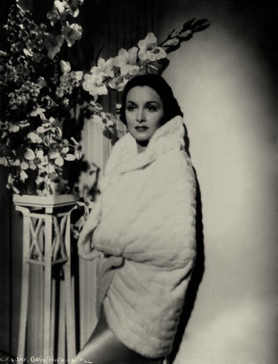 Gail Patrick drapes herself in white mink. 