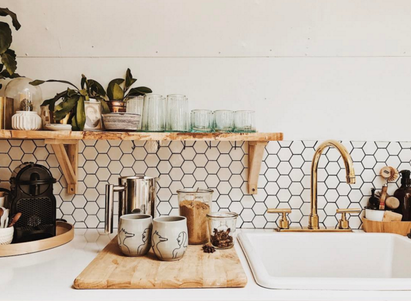 natural wood, honeycomb backsplash tile pattern, and a lot of plants filled this tiny kitchen vintage airstream