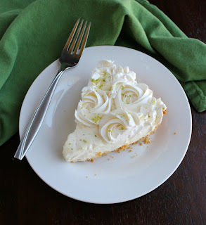This simple no bake key lime pie comes together quickly. It is creamy, dreamy, and oh so good. slice of key lime pie on plate with fork