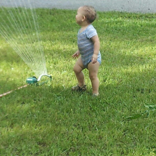 Our baby's first time playing in the sprinkler water spraying everywhere