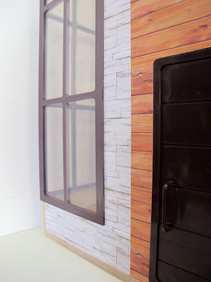 Front view of the modern Lori Loft to Love dolls' house, showing the front door and corner windows.