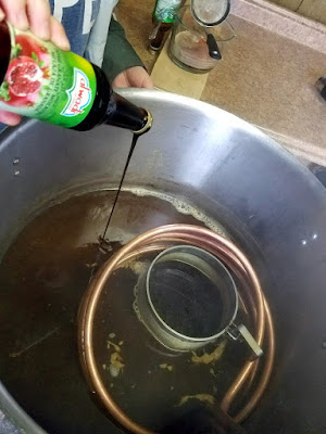 Pouring pomegranate molasses into the wort.