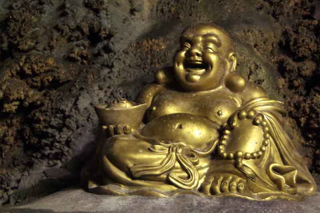 smiling golden Buddha, statue, sitting, cave