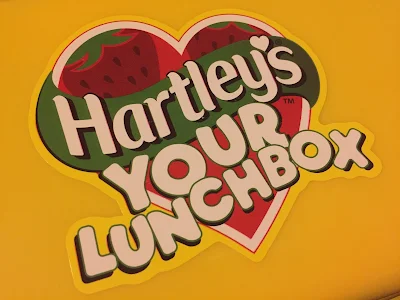 Sticker stating "Hartley's Your Lunchbox" on a yellow background