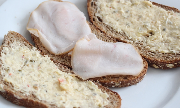 whole wheat bread with thinly sliced chicken and sandwich spread