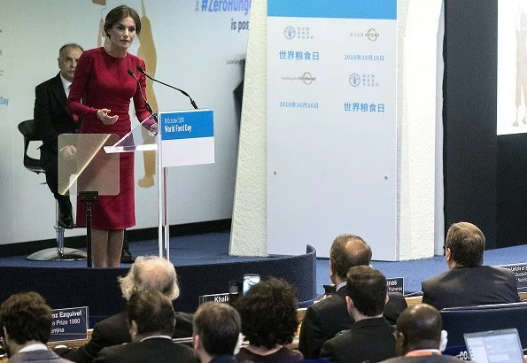 Queen Letizia wore Carolina Herrera red dress, carried Felipe Varela clutch bag. Queen visited the Spanish Royal Academy in Rome