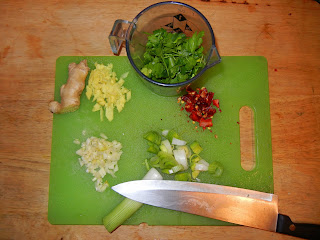 Cutting up the raw ingredients: ginger root, cilantro, chiles, leek and garlic