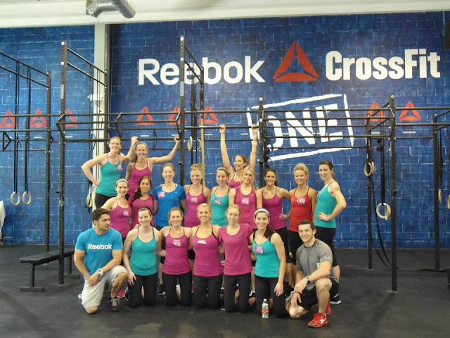 Group photo of Fitfluential bloggers posing for a picture at the  Reebok CrossFit One facility