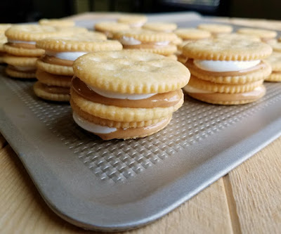 stacks of cracker sandwiches with peanut butter and marshmallow fluff inside, waiting to be dipped