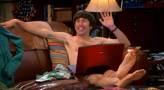 Howard sitting naked in Sheldon's spot on the couch. Howard's groin region is covered by Sheldon's laptop.