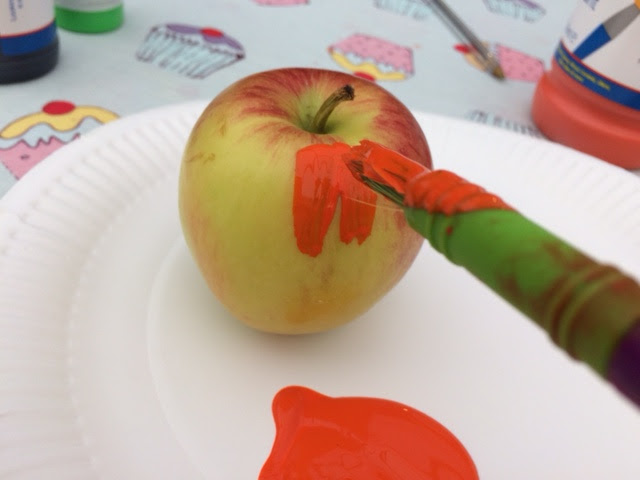 Apple being painted orange