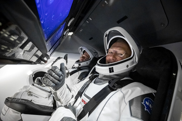 After getting seated inside their Crew Dragon capsule Endeavour, NASA astronauts Douglas Hurley and Robert Behnken pose for a photo before launch on May 30, 2020. After getting seated inside their Crew Dragon capsule Endeavour, NASA astronauts Douglas Hurley and Robert Behnken pose for a photo before launch on May 30, 2020.