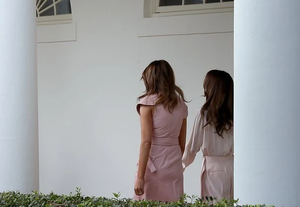 Queen Rania wore a baby pink jumpsuit by Adeam. First Lady Melania Trump wore a pink sleeveless wrap around dress by Proenza Schouler