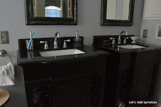 Chrome with black vanities, black granite, white sinks