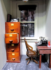 One-twelfth scale miniature 1940s office with filing cabinet, desk and typewriter.