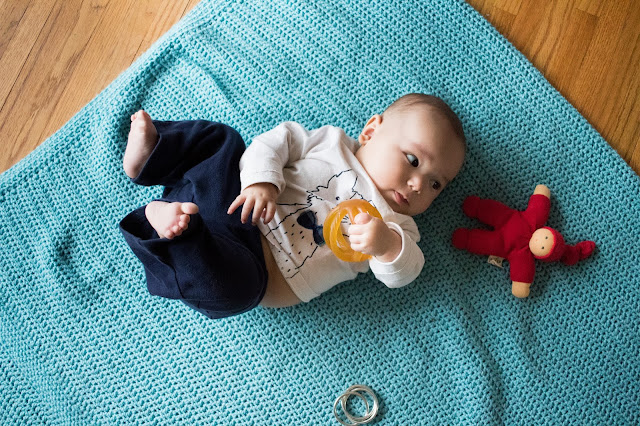 Here are some ways to respond when your Montessori baby is interested in exploring toys! Offering choices and preparing a baby's space become important ways to encourage movement and independence for a young baby. 