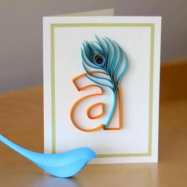 Quilled card with lowercase letter A and aqua paper peacock feather