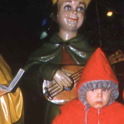boy in front of Christmas decorations