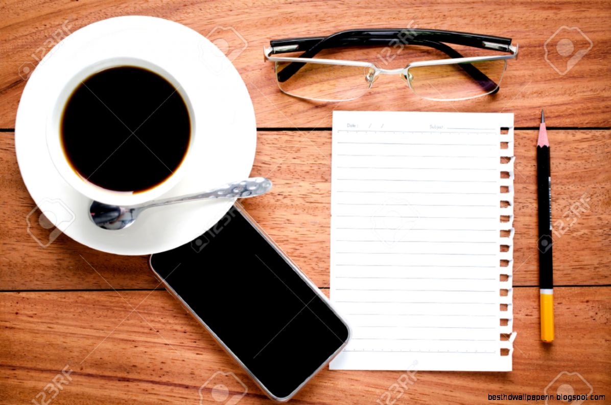 Empty Notebook And A Cup Of Coffee On The Wooden Desk Background