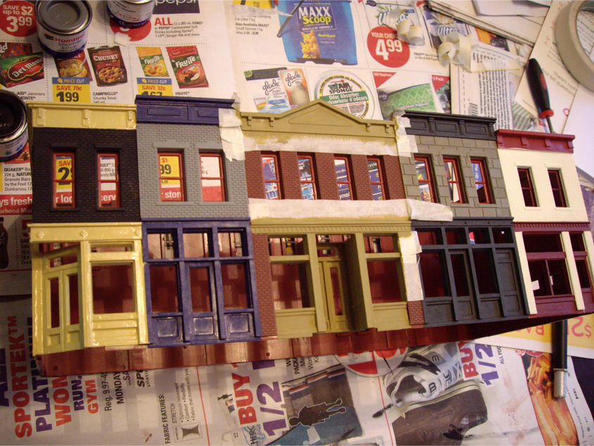 Partially constructed and painted Walthers Merchant’s Row 1 kit with masking tape applied around trim