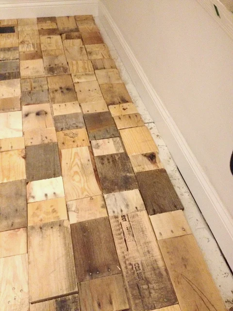 gap between pallet wood floor pieces and wall