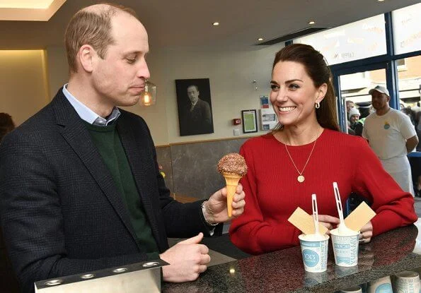 Kate Middleton wore a new navy coat by Hobbs London, and a new knitted puff-sleeve midi dress by Zara. Beulah London Kamala scarf