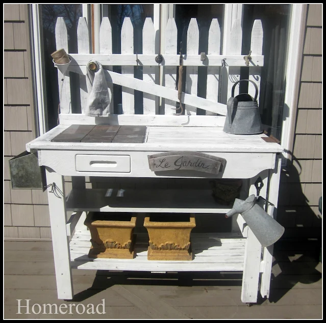 White potting bench built with picket fence pieces