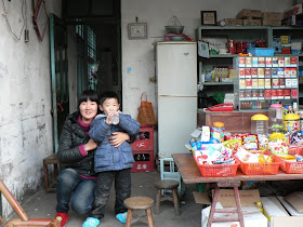 lady with young child in a small convenience store